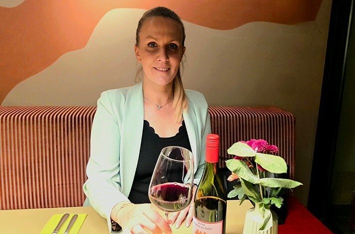 A woman holding a glass of wine