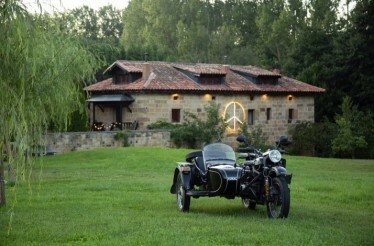 A motorcycle parked in front of a Molino Tejada hotel.
