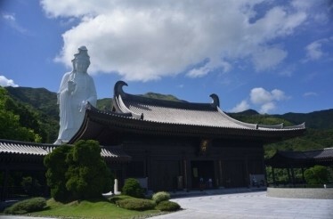 A grand Buddha statue standing behind the Tsz Shan Monastery in Hong Kong.