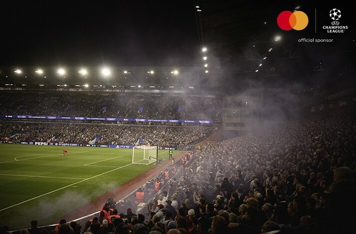Football players and fans photographed during an UEFA Champions League match, view from the audience