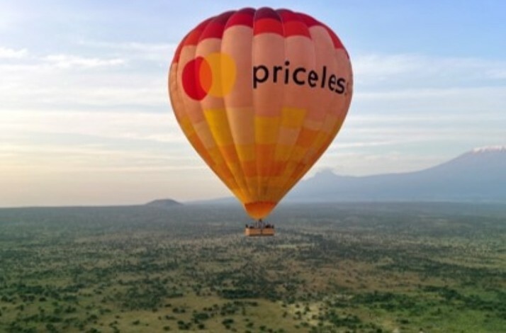 The air balloon with the Priceless logo floating above the Amboseli national park.