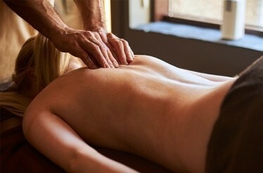 The lady is having a deeply relaxing back massage at the Half Moon's award-winning Fern Tree Spa.