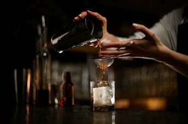A bartender preparing a cocktail.
