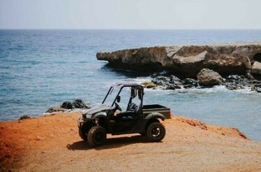 A UTV parked on a quiet beach on the northern coast.