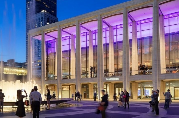 The view at the New York Philharmonic from the front yard with people strolling and taking photos.