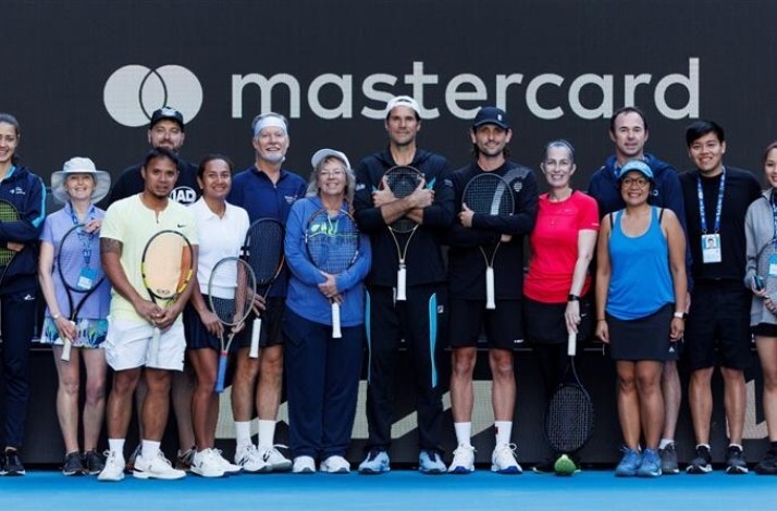 Mark Philippoussis posing with participants at a Mastercard tennis clinic during the Australian Open.