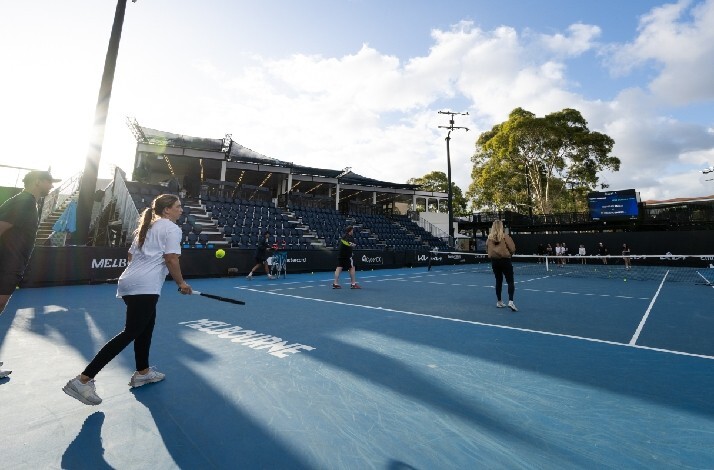 Tennis fans participating in an on-court activity at a Mastercard tennis clinic during the Australian Open.