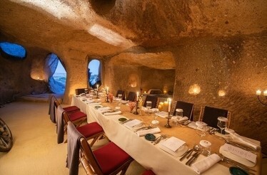 Dining table for twelve people in the candlelit cave near Taskonaklar Hotel.