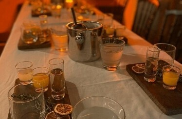 Cocktail making setup at Alkaff Mansion with assorted drinks, garnishes, and mixing tools