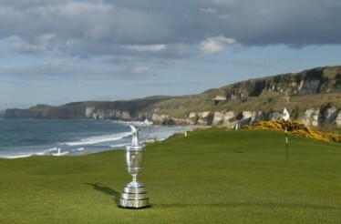 The golf cup standing on the golf field next to coast
