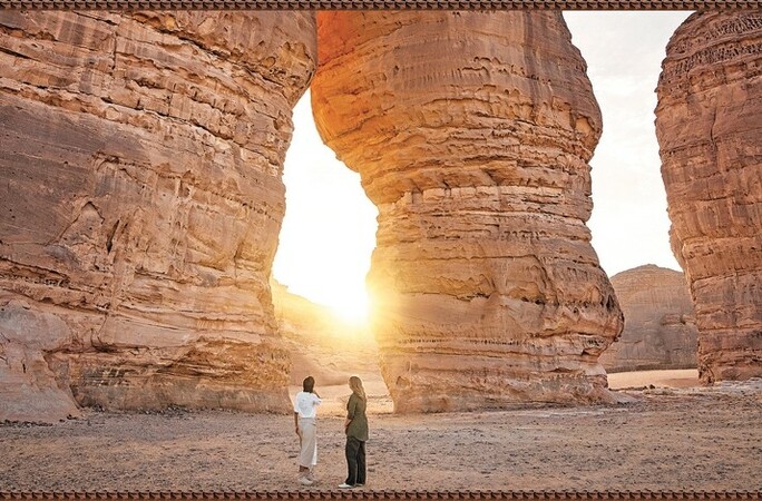 Two people exploring AlUla, an oasis city located in the northwestern Hejaz region.