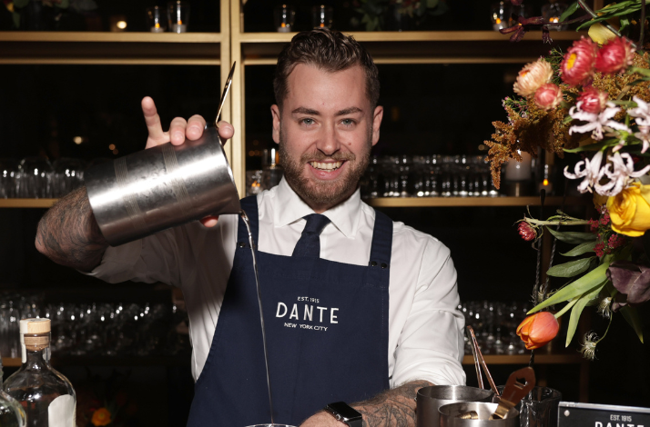A bartender pouring a cocktail at Dante NYC.