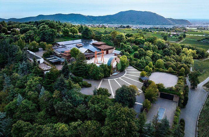 A waiter opening a bottle of wine produced at a historic Franciacorta winery
