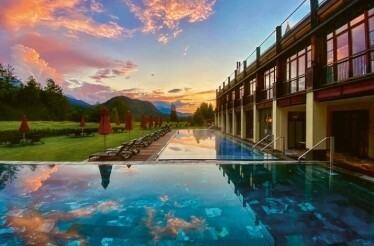 A serene hotel pool surrounded by mountains