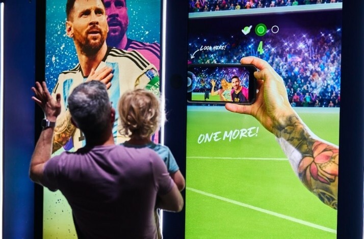 Visitors taking a photo at the Messi Experience