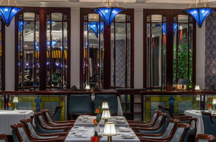 Set tables with blue wooden chairs at the Lobster Bar and Grill.