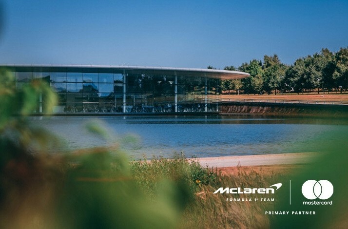 View on McLaren Technology Centre (MTC) and the lake. The image is featured with McLaren and Mastercard logos at the bottom right