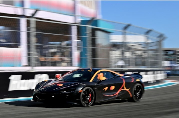 A racing car in motion, featuring Mastercard logo 