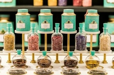 Tea ingredients and blending jars displayed at the tea counter.
