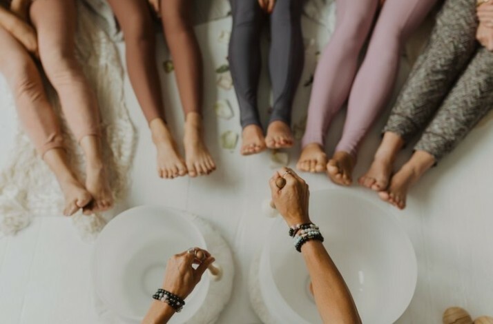 A yoga teacher doing a class to a group of people