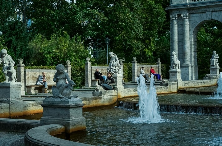 A park fountain ornamented with multiple statues.