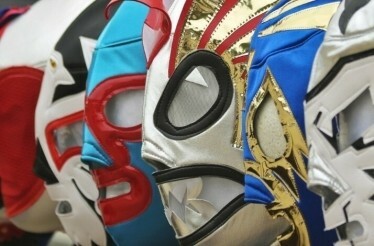 Close-up of vibrant and detailed lucha libre masks on display