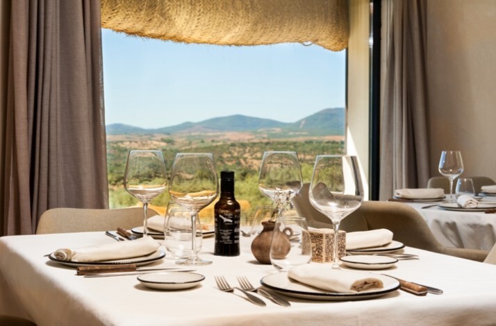 Elegantly set dining table with panoramic countryside views