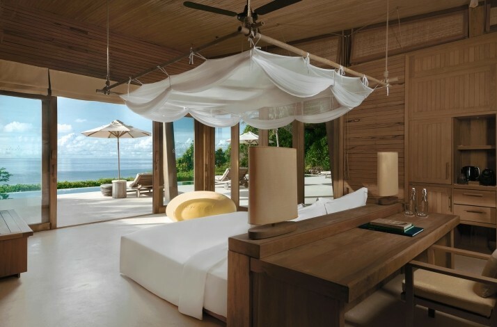 Bedroom in one the villas at the Six Senses Con Dao resort. In the center of the room there is a double bed overlooking the terrace and the sea.