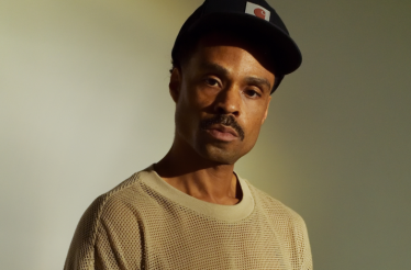 Promotional banner with Bilal, a Grammy Award-winning American singer-songwriter.