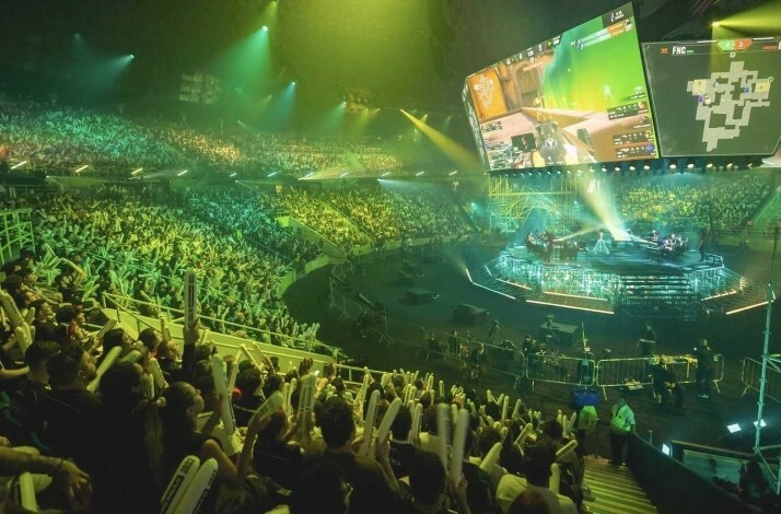 Excited fans in the stands look on at the stage at the 2025 VALORANT Grand Finals in Paris.