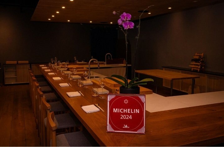 A spacious table set for multiple guests at the Michelin-starred Shota Omakase.