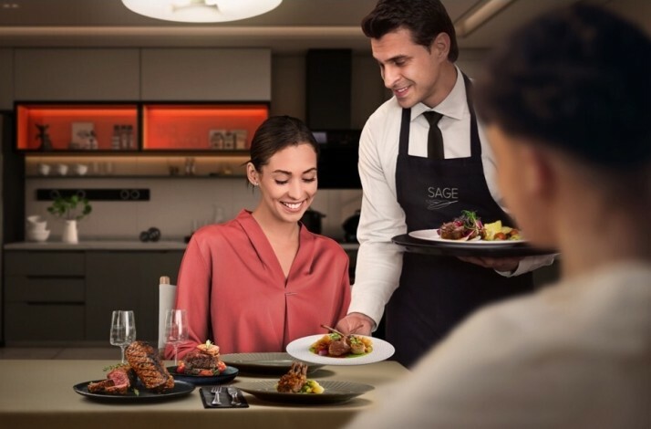 A The Sage Experience butler serving meals to a couple.