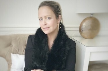 Sharon Warten sitting on a sofa