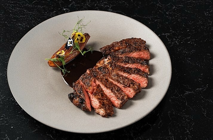 Flame-grilled steak dish served at VUE restaurant.
