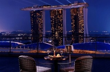 VUE rooftop dining with Marina Bay Sands view at night.