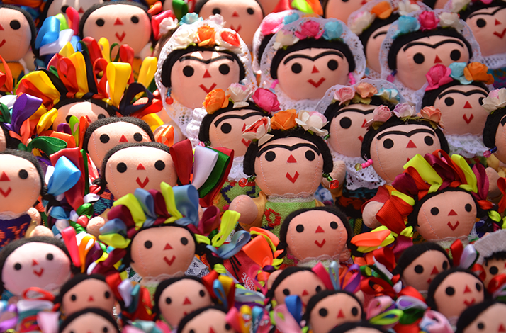 Puppets designed in the likeness of Frida Kahlo, featuring her signature style, iconic unibrow, and vibrant accessories.