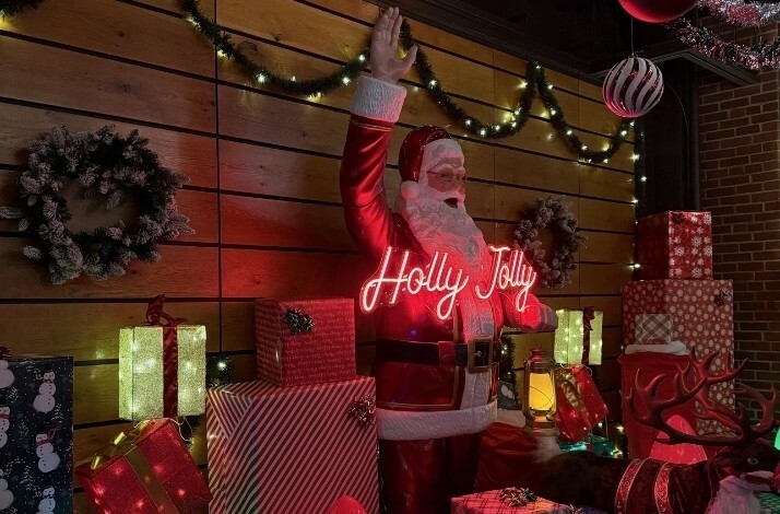 Statue of Santa Clause surrounded by presents at the Holly Jolly Bar.