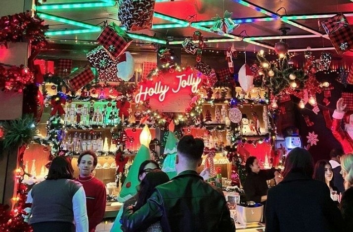 Christmas decorations at Holly Jolly Bar. with visitors being served at the counter