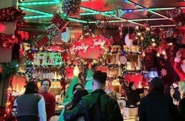 Christmas decorations at Holly Jolly Bar. with visitors being served at the counter