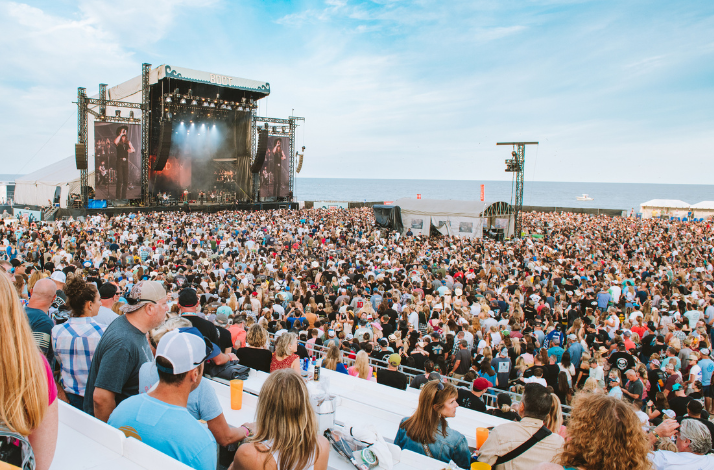 Ocean view at daylight of a band performing live on stage at Country Calling festival from the viewing deck.