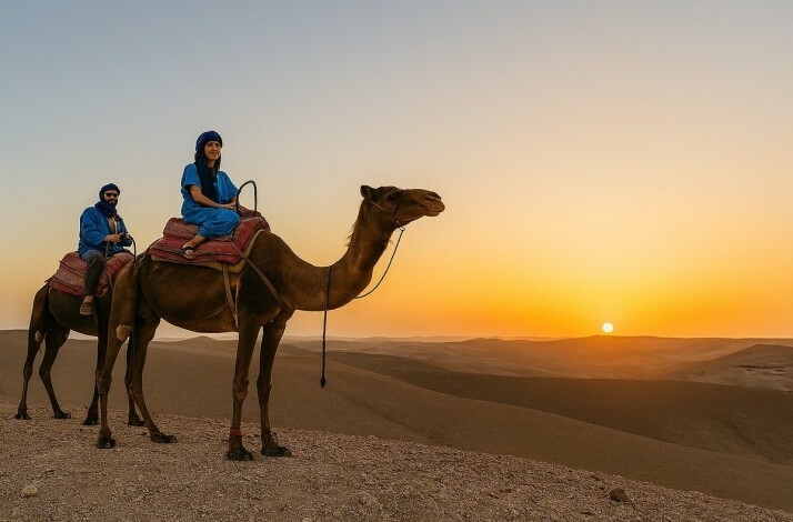 Two camels carrying tourists in Agafay Desert 