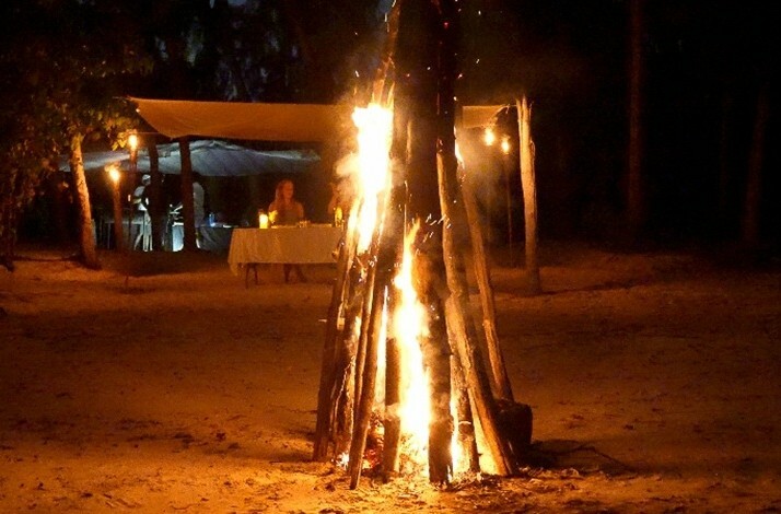 A close-up of a bonfire light on a beach at Île aux Bénitiers, Mauritius.