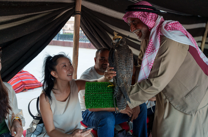 Visitors experience falconry, learning about the UAE’s iconic bird in a Bedouin tent setting