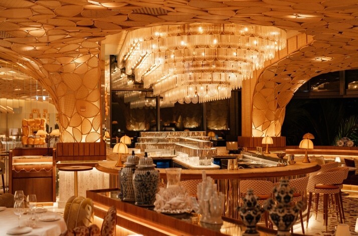 The elegant interiors of Mediterranean and Japanese Restaurant KIRA, featuring gold accents and hand-painted blue ornaments.