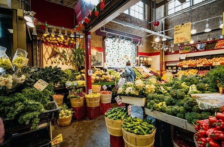 The inside scene of  St. Lawrence Market, showcasing variety of vegetables and fruits up for sale