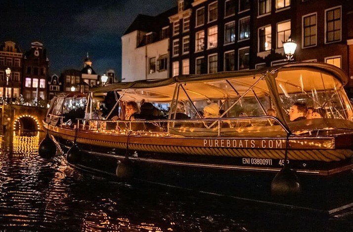 Elegant Pure Spirit on Amsterdam's glowing canals during the Light Festival.