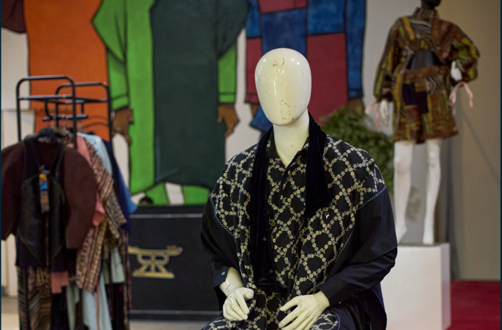 A mannequin dressed in a vibrant traditional African outfit, showcasing intricate patterns and cultural significance.