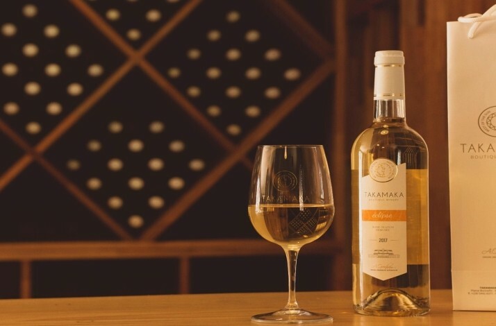 A glass with a bottle of wine from Takamaka Boutique Winery.