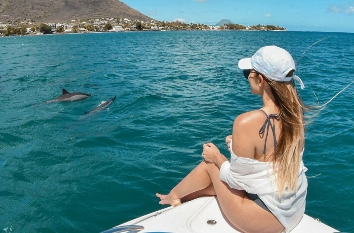 A woman observing dolphins from the boat