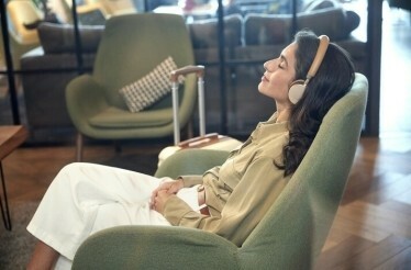 Woman relaxing in a chair with headphones on